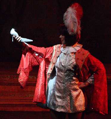 Cinderella Pantomime Broxbourne: Prince Charming studies Cinderella's Slipper